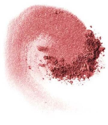 Röd makeup-puder på en vit yta, med lite puder utspritt i en cirkelmönster.