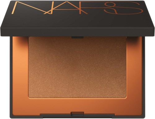 A makeup compact with peachy-colored powder inside, and a black case with brand name on the lid.