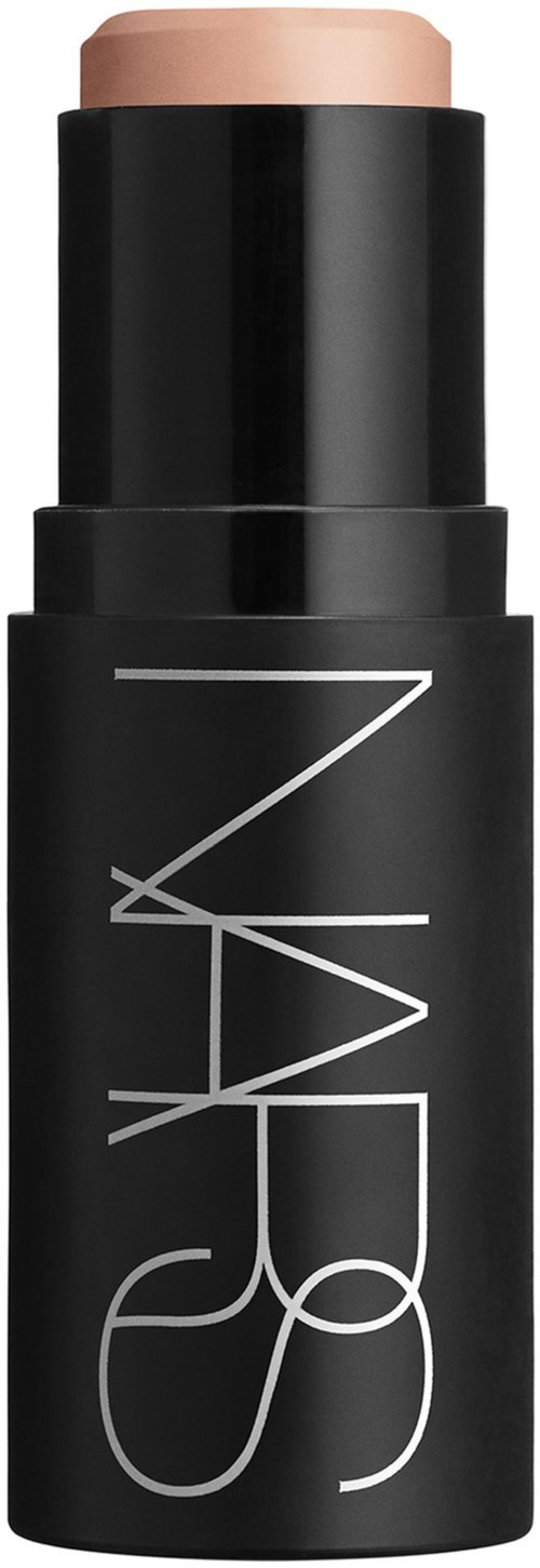 A black cylindrical makeup stick container with a brand name and a beige product visible at the top.