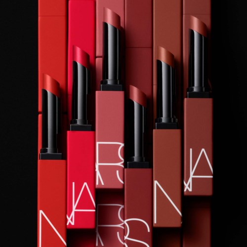 Six lipstick tubes in shades of red and brown with white lettering on a black background.