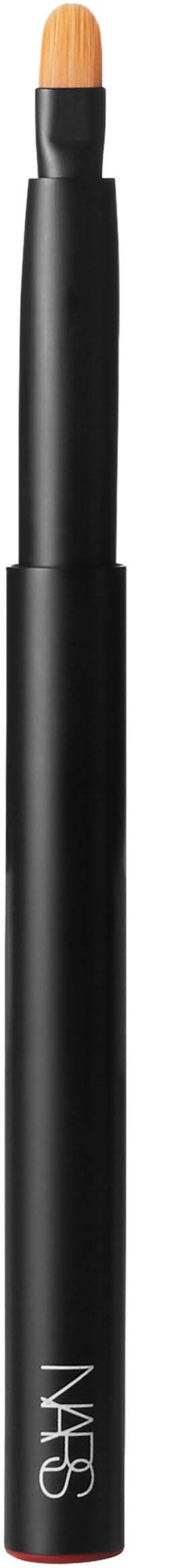 A black makeup brush with a light-colored tip, labeled NARS on the black handle.