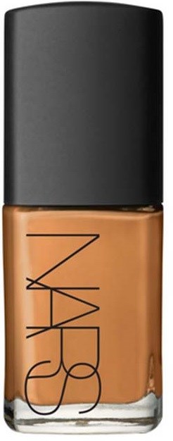 A bottle of NARS foundation with a black cap and tan liquid inside.