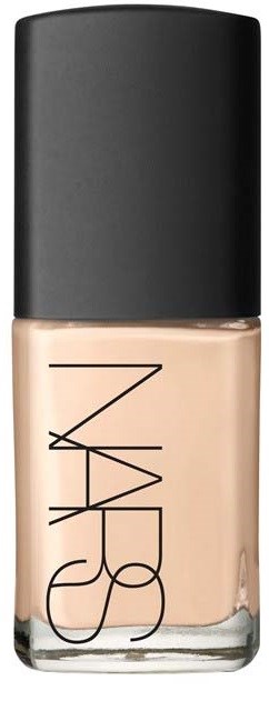 A bottle of NARS foundation with a black cap and clear glass showing skin-colored product.
