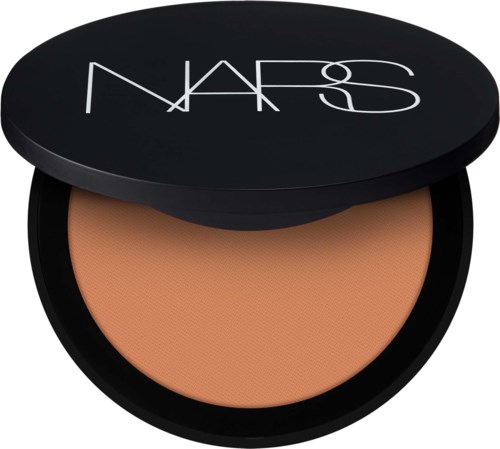 Pieni rasia, jossa on NARS-logo kannessa, sisältää beigepunaista puuteria meikkiin.