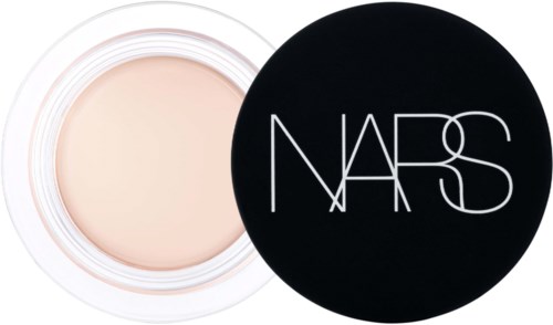 A white container with a light-colored cream inside and a black lid with 'NARS' written on it.