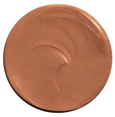 A round makeup foundation with a smooth, light brown color and some brushed strokes on the surface.