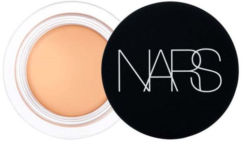 Cream container with a black lid featuring the NARS logo, showing a beige cream inside.