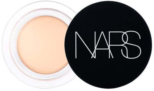 A jar of light-colored cosmetic or skincare product with a black lid featuring the NASA logo in white.