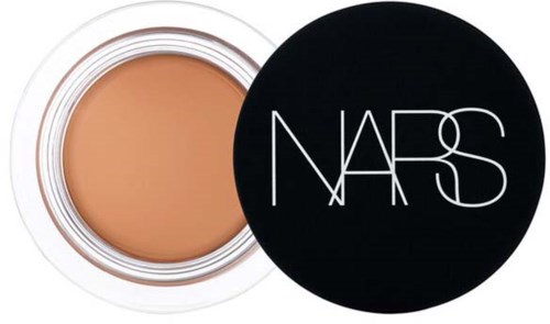 A jar of beige cream with a black lid showing the NARS logo.