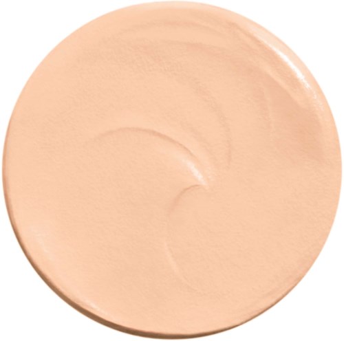 A large, circular, beige-colored makeup product, smooth in texture, with a slightly shiny surface.