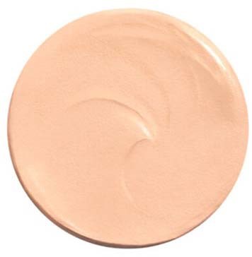 A round, peach-colored makeup foundation swatch with smooth texture and a slight swirl pattern.