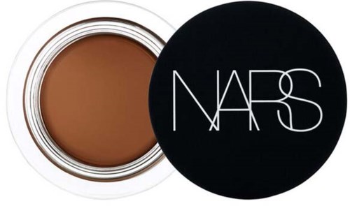 A NARS makeup product in a round container with a black lid and white logo.