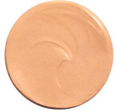 A round compact with beige cream, smooth texture, and a slight swirl on top.