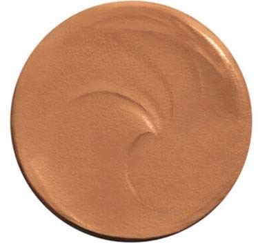 A round makeup product with a shiny, peachy or beige color, smooth surface, and slight swirl pattern.