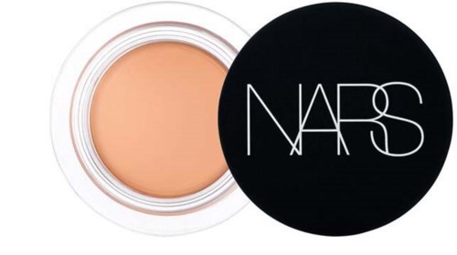 A small jar of concealer with a black NARS lid next to it.