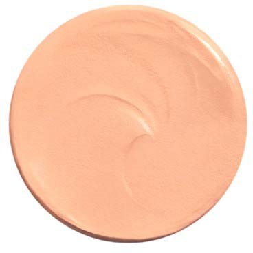 A round, peach-colored cream or lotion with a smooth, shiny surface.
