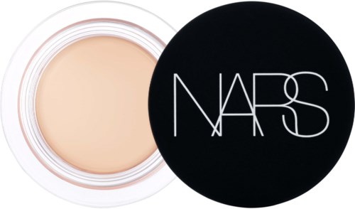 A compact with cream foundation and a black lid with white NARS logo.
