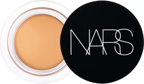 A round container with beige makeup and a black lid with white NARS logo.