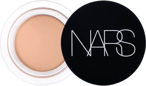 A makeup compact with beige foundation and a black lid with white NARS logo.