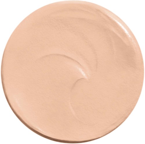A pale beige makeup compact rests on a white background.