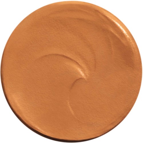 A round, beige makeup product with a smooth surface and curved lines inside.
