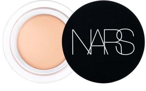A open makeup compact with beige powder and a black lid with white NARS logo.