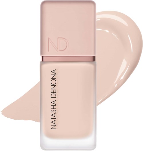 Eine rosa Nagellackflasche mit einem herzförmigen Fleck davon.