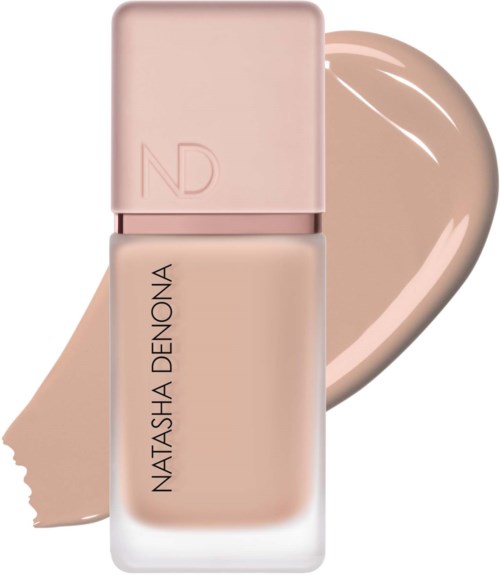 Eine Flasche Make-up mit hellbeige Farbe und rosa Deckel, namens Natasha Denona.