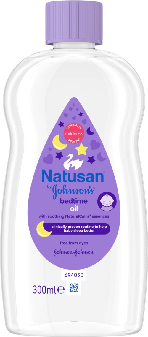 A transparent bottle with a purple cap containing bedtime oil for children by Natusan Johnson, featuring moon and star illustrations.