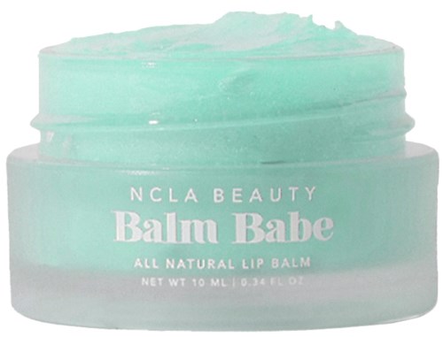 A small jar of green lip balm with white text: NCLA Beauty, Balm Babe, all natural, net 10 ml.