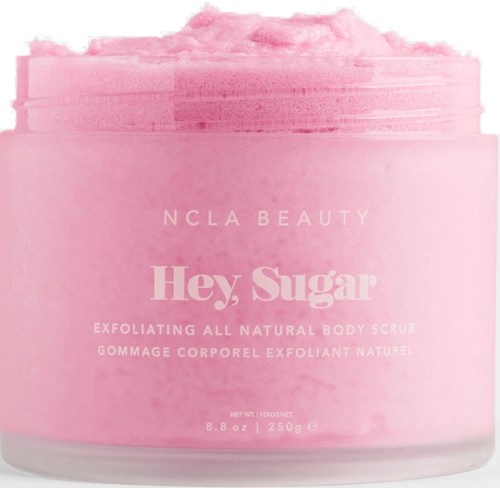 Pink jar of natural body scrub called "Hey, Sugar" by NCLA Beauty. It is exfoliating and contains sugar.