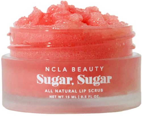 A pink lip scrub in a jar, labeled NCLA Beauty Sugar Sugar, with a thick, sugar scrub texture on top.