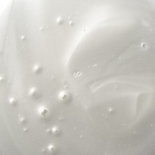 Close-up of a creamy, white skincare product with small bubbles.