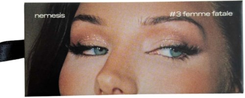A makeup product box shows a woman with eye makeup, blue eyes, and dark hair. It has the words 'nemesis' and 'femme fatale.'