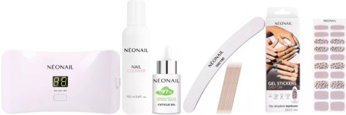 A nail care kit with UV lamp, gel, nail clips, stickers, and tools for manicures and pedicures.