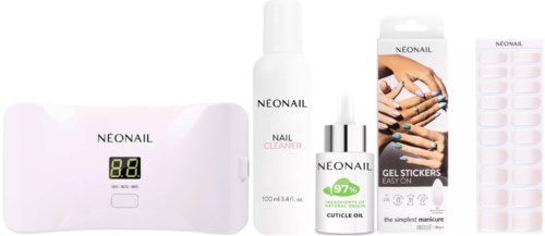 Set of nail care products including a lamp, cleaner, gel stickers, and nail polish for healthy nails.