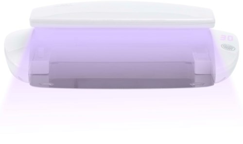 A white device with a purple glow, possibly a scanner or a small flat machine, with buttons on the side.