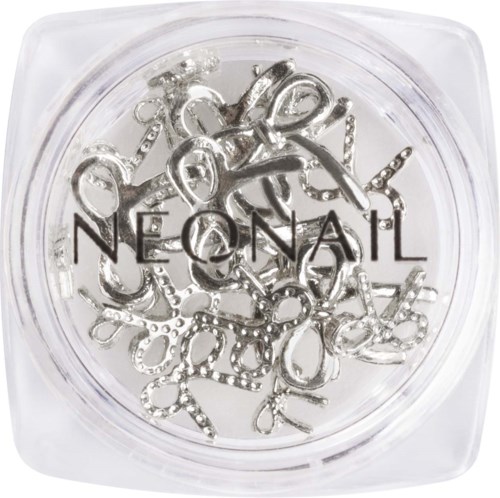 A clear container with silver jewelry pieces, including rings, chains, and decorative letters.