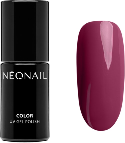 A black bottle of nail polish and a painted nail with dark pink color.