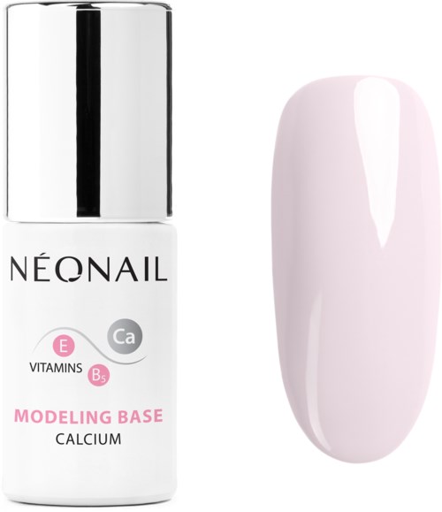 A bottle of nail modeling base with calcium next to a painted nail tip. The bottle has a white label and silver cap.