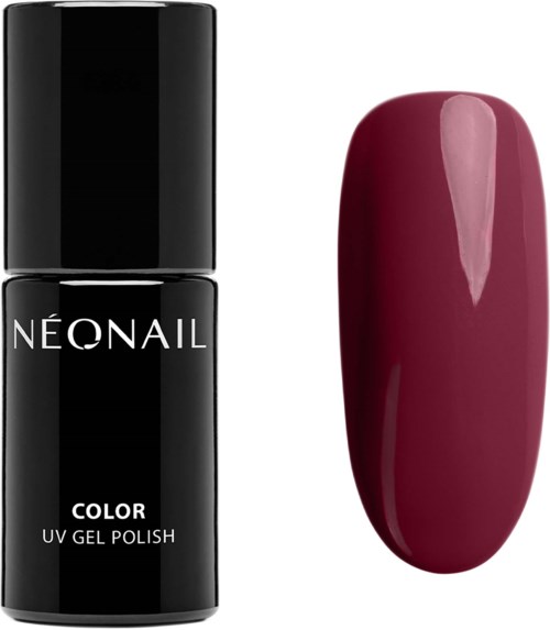 A bottle of neon nail polish and a painted nail showing a deep pink color.