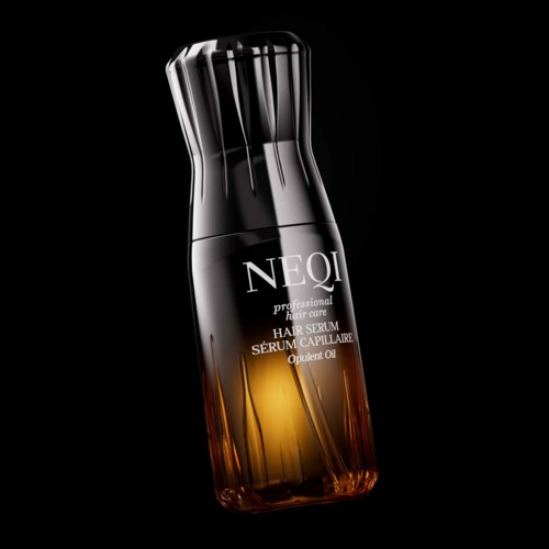 Een strakke, zwarte en amberkleurige fles haarserum met modern ontwerp en zilveren dop.
