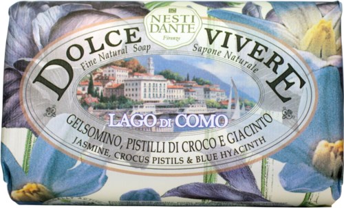 Soap packaging with a picture of a lake, buildings, and flowers on the label, showing the soap's scent and origin.