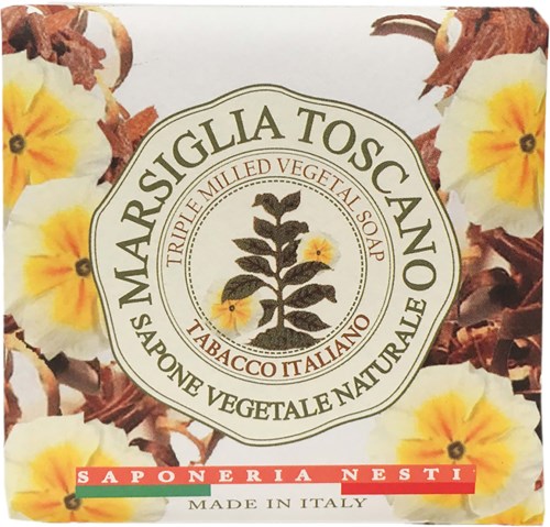 Soap packaging with yellow flowers and a central logo. Text indicates it's a natural, Italian, vegetable soap with tobacco scent.