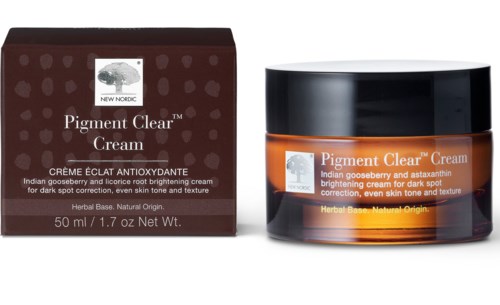 Förpackning för Pigment Clear Cream med en orange burk, mörk lock och en box som visar produktdetaljer.