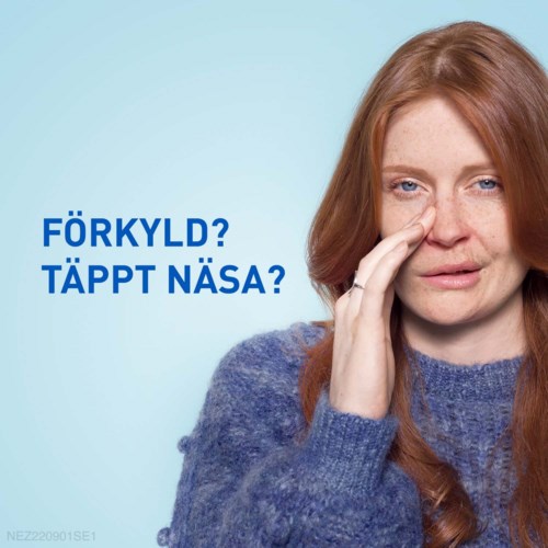 En kvinna med rött hår som rör vid sin näsa, ser obekväm ut, med svensk text som frågar om förkylning eller täppt näsa.