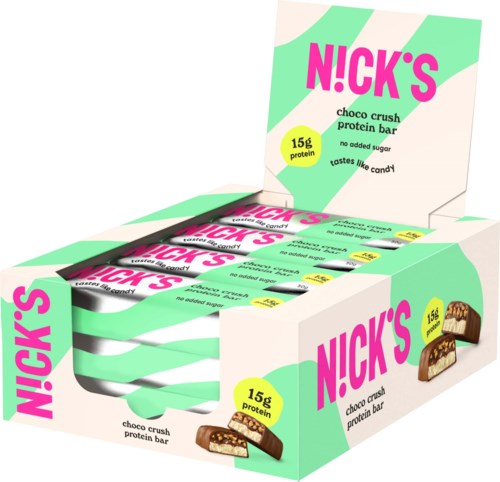A display box with multiple protein bars labeled Nick's choco crush, showing 15g protein and no added sugar.