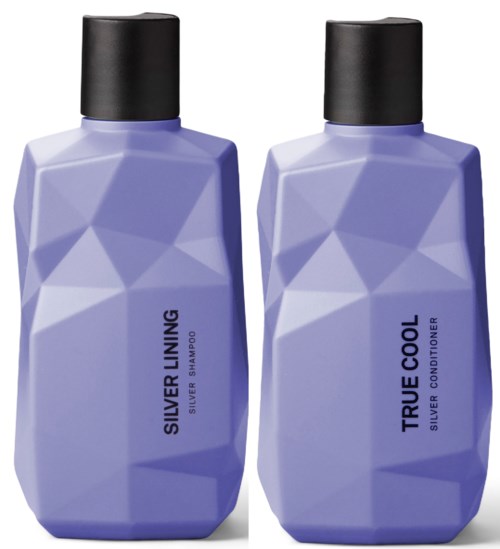 Two purple bottles of silver shampoo and conditioner with black caps, geometric design, and simple labels.