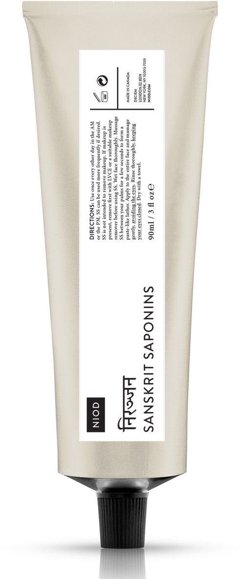 En beige tube med svart kork, merket 'Niod' og 'Patchouli Sanskrit Saponins', sannsynligvis et hudpleie- eller kosmetikkprodukt.