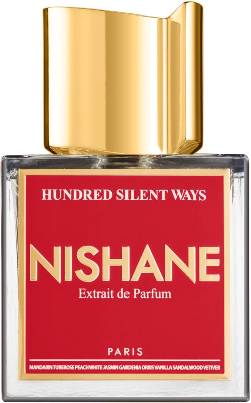 Een parfumfles met een gouden dop en een rood label dat 'NISHANE' en 'Extrait de Parfum' zegt.